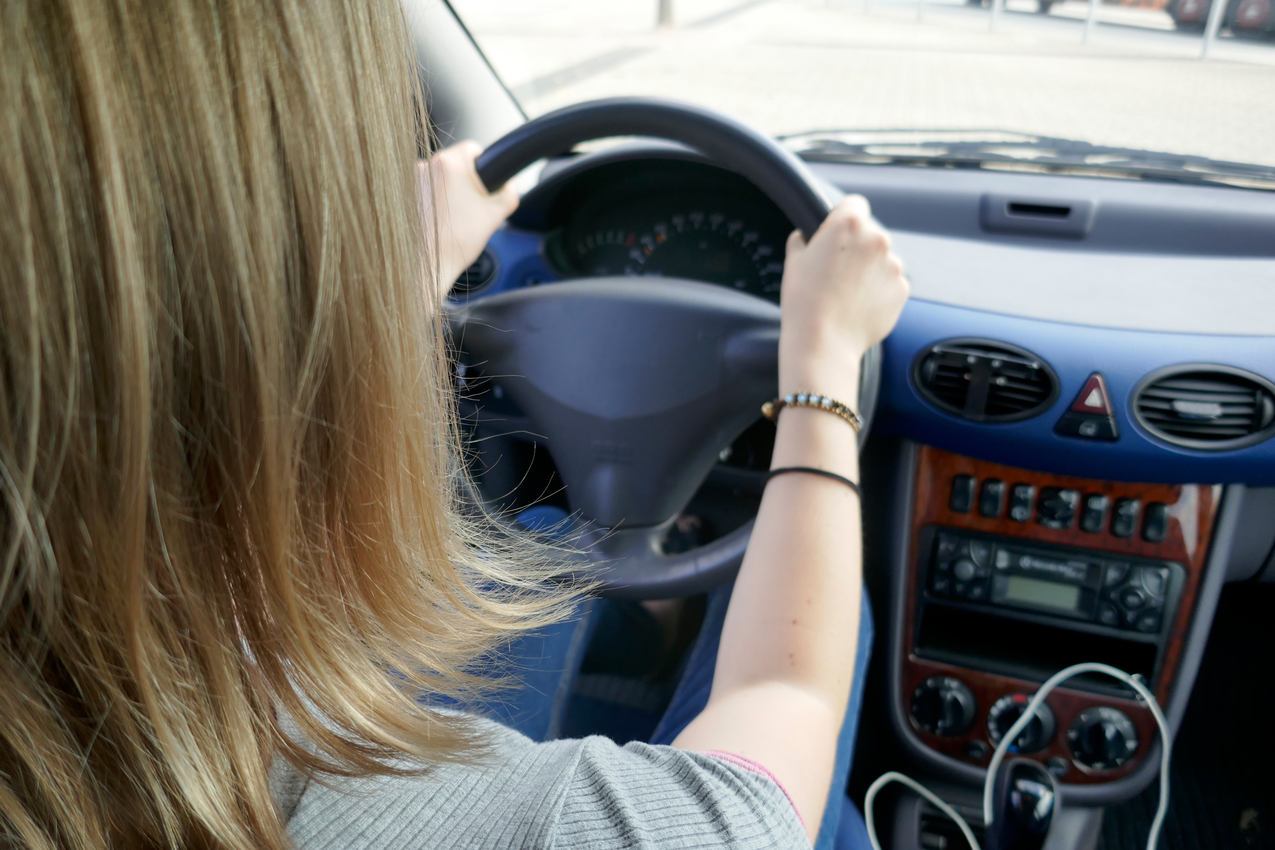 A Young Woman Drives By Car